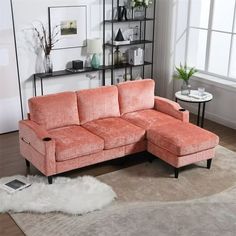 a living room with an orange couch and white rug