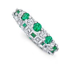 an emerald and diamond ring with white diamonds on the sides, set in 18k white gold