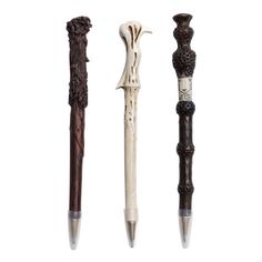 three different types of pens are lined up in a row, one is white and the other is brown