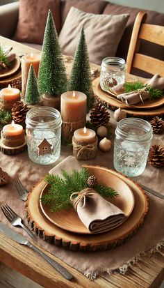 a table set for christmas with candles, napkins and pine cones on the plates