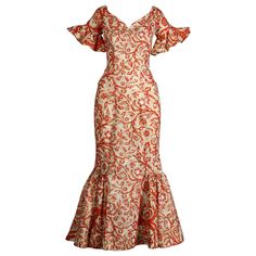 Rare 1950s Hawaiian dress made by Surf and Shore in Honolulu. Mouth watering vintage hand pulled screen printed fabric in orange, white and metallic gold. Dramatic flared bell sleeves and plunging neckline. 1950s bombshell hourglass silhouette! Unlined with rear metal zip and hook closure. The fabric content feels like cotton but is unmarked. Fits like a modern size XS. The bust measures 34", waist, 24", hips 35", and total length 52.5". The bottom hem has about 1.5"-2" that can be let out. Excellent vintage condition with no noted flaws. The fabric is still nice and crisp. Made in the USA. Islander Dresses Design, Hawaiian Dress Pattern, Traditional Hawaiian Dress, 1950s Bombshell, Dress Hawaiian Style, Island Style Clothing, Polynesian Dress, Vintage Hawaiian Dress, Hawaiian Fashion