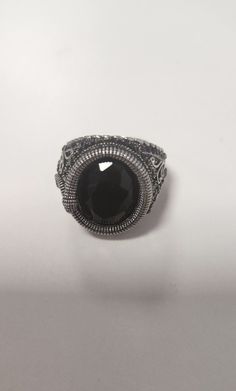 a black stone ring sitting on top of a table