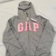 Vintage Soft Gap Arch Logo Zip Up Hoodie Grey With Pink Logo Tags Attached Brand New Never Worn Pink Cotton Hoodie By Gap, Gap Winter Tops With Letter Print, Gap Letter Print Tops For Winter, Gap Tops With Letter Print For Winter, Gap Cotton Hooded Top, Gap Hoodie With Letter Print, Gap Hooded Hoodie With Letter Print, Pink Gap Sweatshirt For Winter, Gap Pink Winter Hoodie