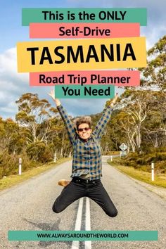 a man standing on the side of a road holding up a sign that says self - drive tasmania road trip planner you need