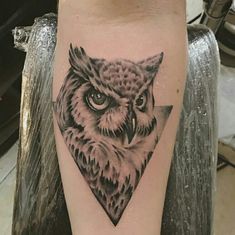 an owl tattoo on the leg