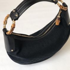 This Vintage Gucci Bag Is In Brand New Condition And Has Never Been Used. Black 'Gg' Monogram Canvas And Grained Leather Trim "Medium Bamboo Ring" Hobo Bag From Gucci. Gold-Tone Hardware Details. Single Handle With Large Circular Bamboo Accents. Top Zipper For Closure With A Bamboo Accent On The Pull Tab. Interior Lining Features A Zip Pocket. Comes With Storage Bag. Gucci Black Bag With Bamboo Handle, Black Gucci Bag With Bamboo Handle, Vintage Gucci Bag, Bamboo Ring, Gucci Vintage Bag, Bag Gucci, Gg Monogram, Gucci Bamboo, Gucci Bags