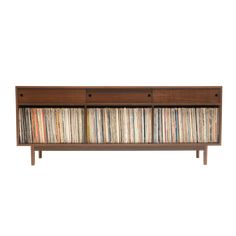 an entertainment center with several records on the front and side shelves, all in different colors