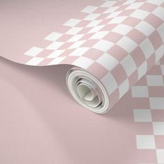 a pink and white checkered wallpaper with a rolled up roll on the side