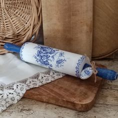 two rolls of paper on top of a cutting board next to a wicker basket