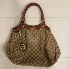 100% Authentic Gucci Tote. Canvas With Brown Leather Details. Snaps On Sides To Expand. Zipper On Inside. Gucci Brown Signature Coated Canvas Bag, Gucci Tote Bag With Leather Trim, Leather Scarf, Canvas Leather Tote, Pre-owned Brown Gucci Bag, High-end Gucci Tote Bag, Gucci Purse, Gucci Tote Shoulder Bag With Gold-tone Hardware, Gucci Monogram