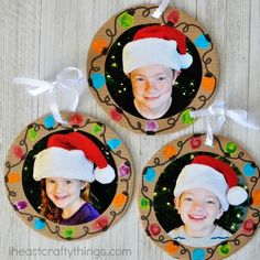 three christmas ornaments with two children's faces in santa hats on the front and back