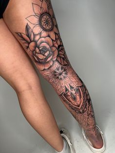 a woman's leg with flowers on it