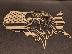 an eagle and the american flag on a black surface