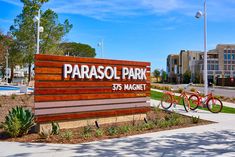 two bikes are parked in front of the sign for parasol park 35 magnificent drive