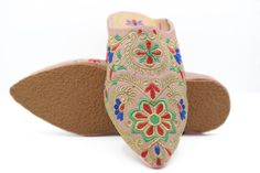 Bring a Moroccan touch to your outfit with these leather mules for women. They are hand stitched in a family workshop in the heart of the medina of Marrakesh using naturally tanned leather. The upper is decorated with multi colored pompoms, tassels and embroideries. A Moroccan pompom slippers handmade in Marrakesh, known for its quality leather. In fact, this city has one of the oldest tanneries in the kingdom where leather is still working in a natural way. Hurry, take advantage of our best off Traditional Handmade Clogs With Round Toe, Traditional Closed Toe Clogs, Traditional Round Toe Slippers For Spring, Traditional Handmade Closed Toe Clogs, Traditional Closed Toe Leather Mules, Traditional Closed Toe Mules For Festivals, Traditional Leather Closed Toe Mules, Traditional Leather Mules For Spring, Handmade Leather Slippers