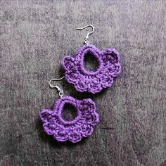 purple crochet earrings on grey background