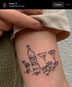 a woman with a tattoo on her arm holding a wine bottle and two martini glasses