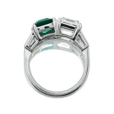 Asscher Diamond and Emerald Toi et Moi Ring The Braxton 2.90 ring is an AB original design made right here in NYC. The ring features a GIA-certified 2.90-carat Asscher Cut diamond of J color, VS1 clarity and a 1.68-carat C Dunaigre-certified Octagonal cut Zambian Emerald with minor enhancement. On either side of the stones are tapered baguette diamonds totaling approximately 0.40 carats. The stones are set in a platinum setting. The ring is currently size 6 and can be resized! Why We Love It A p Gia Certified Classic Emerald Ring, Timeless Green Platinum Rings, Classic Green Platinum Ring, Classic Green Platinum Rings, Classic Brilliant-cut Emerald Ring In Platinum, Classic Platinum Emerald Ring With Brilliant Cut, Timeless Platinum Emerald Ring For Formal Events, Platinum Emerald Ring With Vvs Clarity, Formal Platinum Emerald Ring With Vvs Clarity