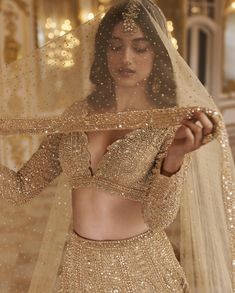 a woman in a gold wedding outfit