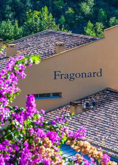 a building with purple flowers in front of it and the word fragonard on top