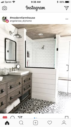 a bathroom with white walls and black and white floor tiles on the floor, along with two sinks