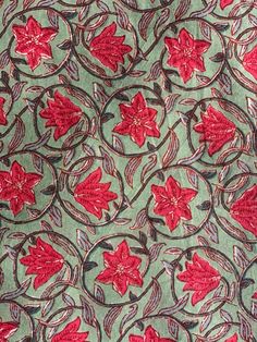 a red and green floral design on fabric