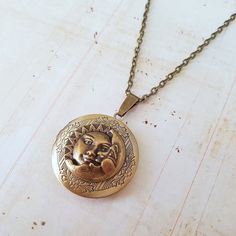 Sun and Moon Face Locket Necklace Solar System | Etsy Bohemian Brass Locket Necklace With Vintage Charm, Bohemian Brass Locket Necklace, Bohemian Antique Gold Brass Locket Necklace, Handmade Antique Gold Brass Locket Necklace, Bronze Round Brass Locket Necklace, Bronze Bohemian Locket Necklace, Antique Gold Medallion Locket Necklace In Bohemian Style, Antique Adjustable Locket Necklace, Bohemian Antique Gold Medallion Locket Necklace