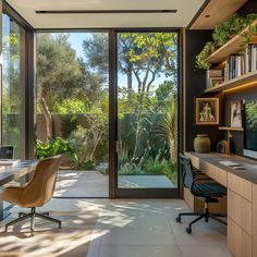 a home office with glass doors leading to an outside patio and trees in the background