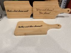 three wooden cutting boards with writing on them