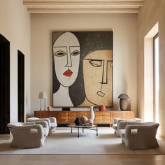 a living room filled with furniture and a painting on the wall