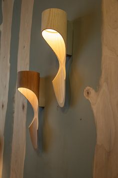 two wooden lights on the wall next to each other