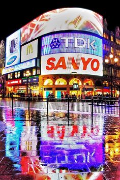 a large building with many lights on it's sides and the words sanyo