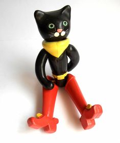 a black and yellow cat figurine sitting on top of a red object