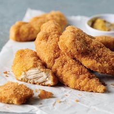 fried chicken tenders with dipping sauce on the side