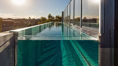 an empty swimming pool with the sun reflecting off it's side walls and windows