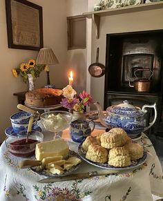 a table topped with lots of food next to a fireplace