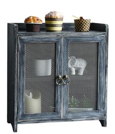 an old blue cabinet with cupcakes and muffins on top