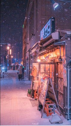 a street scene with snow falling on the ground