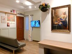 a living room filled with furniture and a flat screen tv mounted to the side of a wall