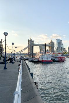 a boat is in the water near a bridge