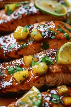 grilled salmon with pineapple salsa and limes on the side, ready to be eaten