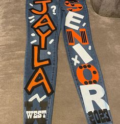 Please add your school name, colors and your size! Fitted Letter Print Denim Jeans, Trendy Fitted Jeans With Letter Print, Fitted Denim Bottoms With Letter Print, Trendy Denim Jeans For School, Painted Spirit Jeans, Spirit Jeans Ideas, Senior Jeans Ideas High Schools, Senior Pants Ideas, Senior Pants High Schools