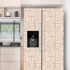 a kitchen with white cabinets and beige patterned refrigerator freezer door covers in the center