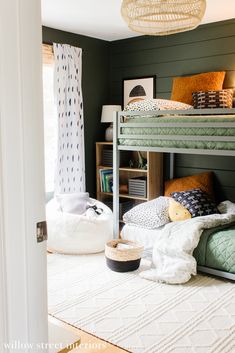 a bunk bed in a room with green walls and white rugs on the floor