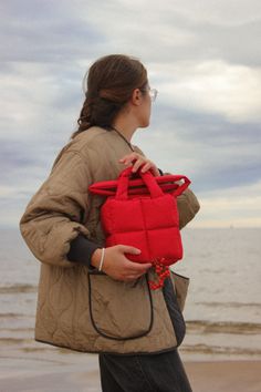 New kid on the block, mini version of our Pillow Puffer bag : Baby Pillow Essential bag in gorg red color 🍊 A spectacular accessory for your look in any season. Also our novelty: from now on your garment will have its own dust bag 🌼 The most huggable piece in your wardrobe. This bag is made of waterproof raincoat fabric with cotton lining. Needless to say this is the epitome of soft & cozy. Perfect piece for everyday life. Bag is equipped with two pockets for small items and convenient handles Stripped Beanie, Red Bag Outfit, Bag Shapes, Puffer Bag, Red Tote Bag, Baby Pillow, Bag Outfit, Red Tote, Red Bag