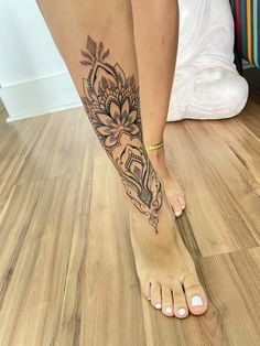 a woman's foot with a tattoo on it