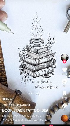 an image of a book stack tattoo idea on a sheet of paper next to some scissors