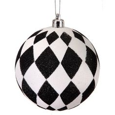 a black and white ornament hanging from a chain