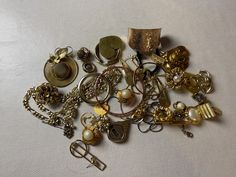 This is a 1/2 pound lot of broken and not, vintage and newer craft jewelry. The majority of these are wearable or for crafts, Golden tones There are necklaces, earrings, bracelets, key rings, broken pieces etc etc. Both vintage and modern. Perfect for your slow stitches or scrapbooking projects. Or other works of art This is NOT a mystery bag or box, so there will be no surprises You get everything in the picture. So study the pictures carefully Various materials such as plastic, metal, beads, etc etc Broken Pieces, Mystery Bag, Craft Jewelry, New Crafts, Scrapbooking Projects, Metal Beads, Key Rings, Jewelry Crafts, Jewelry Sets