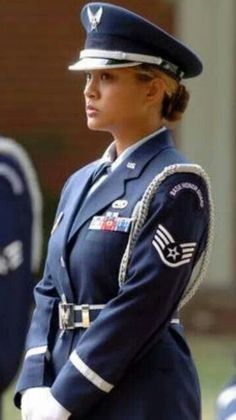 a woman in uniform standing next to other people